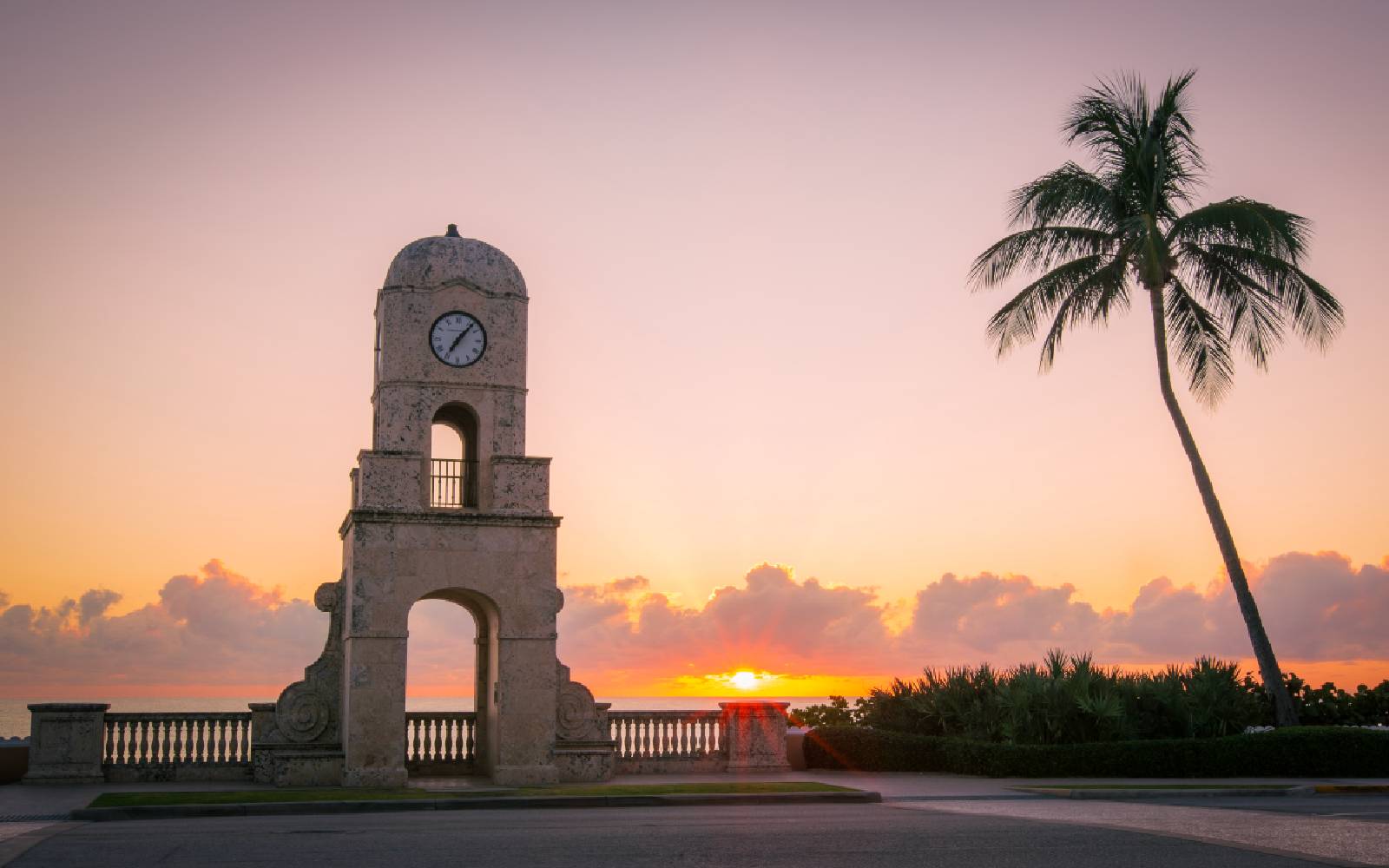 Palm Beach coastline at sunrise, clock tower and palm trees
